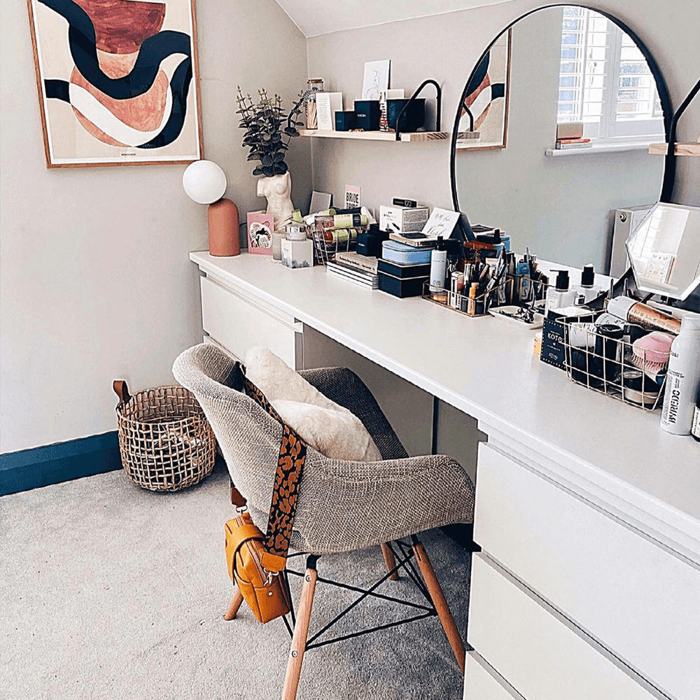 Grey Olivia fabric armchair at a white dressing table