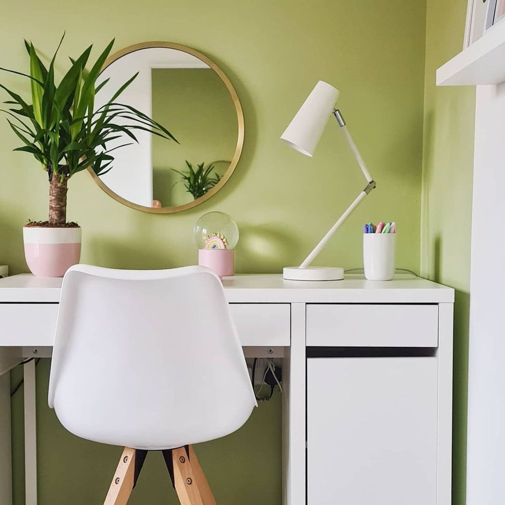 White Jamie Lorenzo chair at a white desk against a green wall