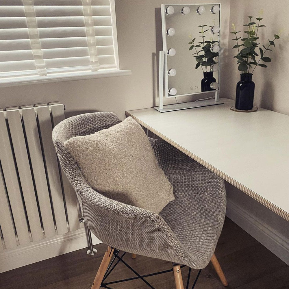 Grey Olivia fabric armchair with a boucle cushion at a dressing table
