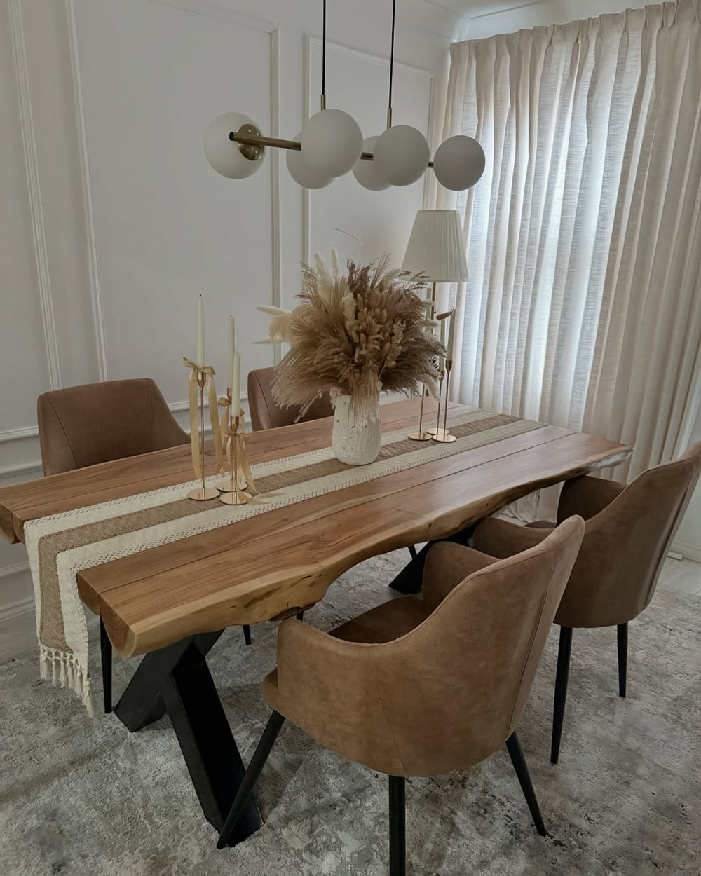 Brown faux leather dining chairs around a live-edge wooden dining table