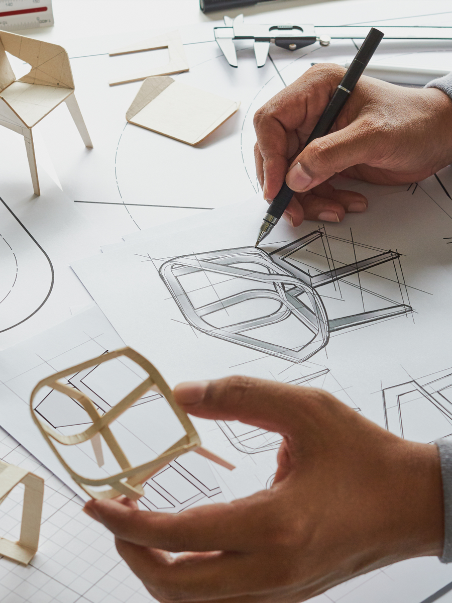 A designer sketching a dining chair